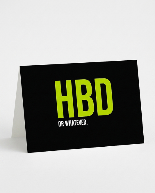 A black A5-sized greeting card with a fold-down stand, featuring the text 'HBD OR WHATEVER.' in bright lime green and white, set against a clean white background.