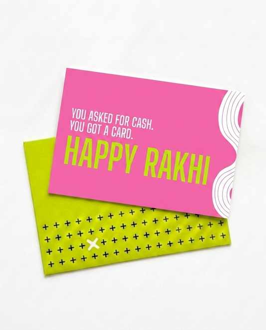 A pink and lime green greeting card set with 'HAPPY RAKHI' text, photographed on a clean white background.